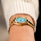 Bulova Super Seville Jardin Bleu — Side profile showing the coin-edge bezel, crown and polished gold links, with the custom hand-painted floral dial in view, a bespoke timepiece by IFL Watches.
