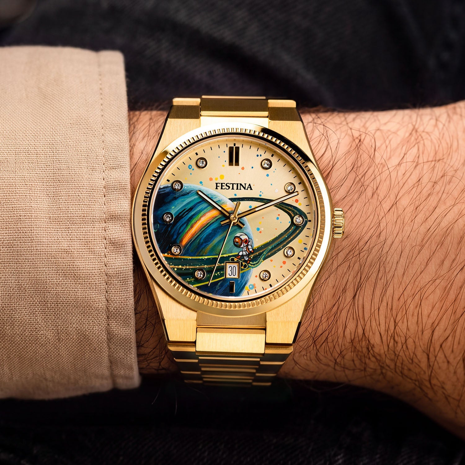 Festina Rive Space Ollie — Custom hand-painted dial viewed at the wrist, showing a ringed planet, scattered paint flecks and crystal-set markers in gold, a bespoke timepiece by IFL Watches.