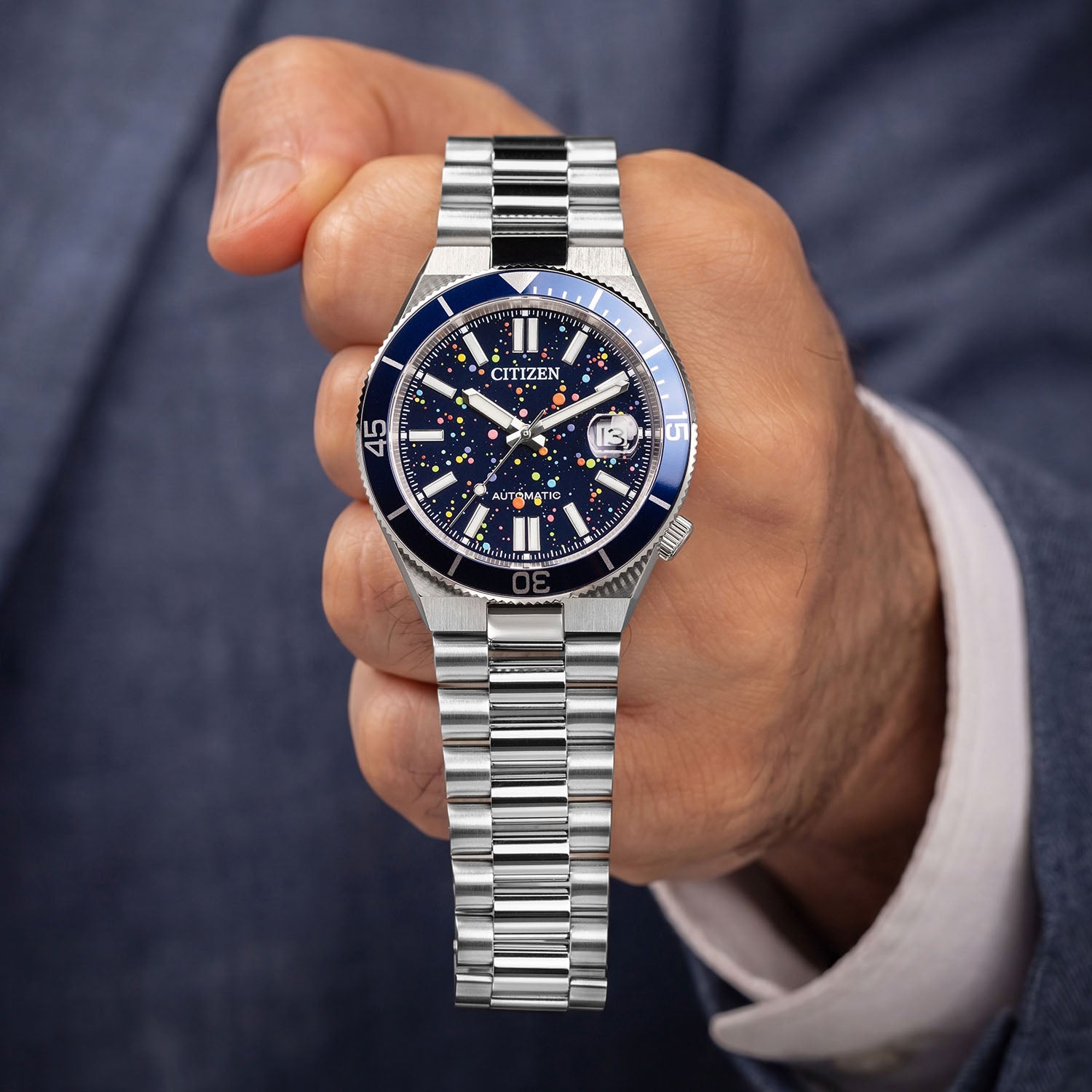 Citizen Tsuyosa Shore Midnight Sky held in hand — full view of the hand-painted pointillism dial and stainless steel bracelet, limited edition timepiece by IFL Watches.