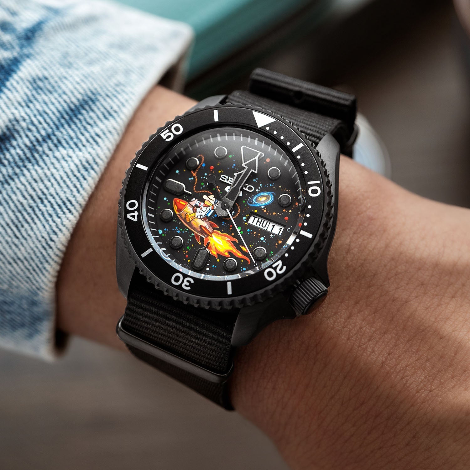 Space Cowboy Concept – Hand-painted custom Seiko 5 Sports featuring cosmic cowboy riding rocket through space, bespoke timepiece by IFL Watches