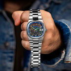 Bulova Super Seville Scream — Held in a closed fist toward the camera, full steel bracelet hanging below the custom dial, limited edition timepiece by IFL Watches