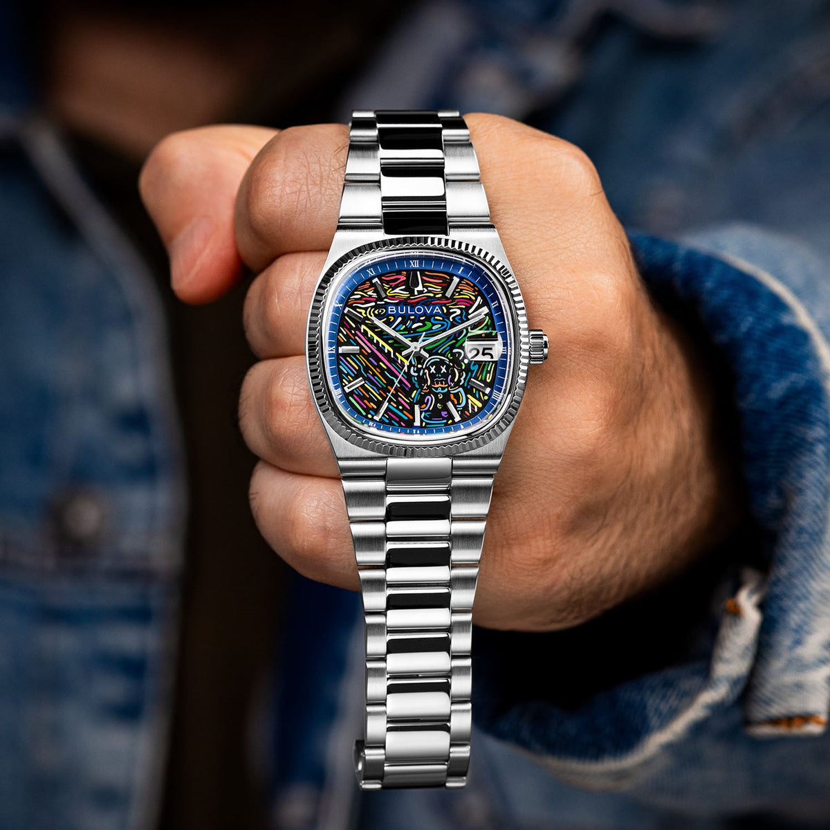 Bulova Super Seville Scream — Held in a closed fist toward the camera, full steel bracelet hanging below the custom dial, limited edition timepiece by IFL Watches