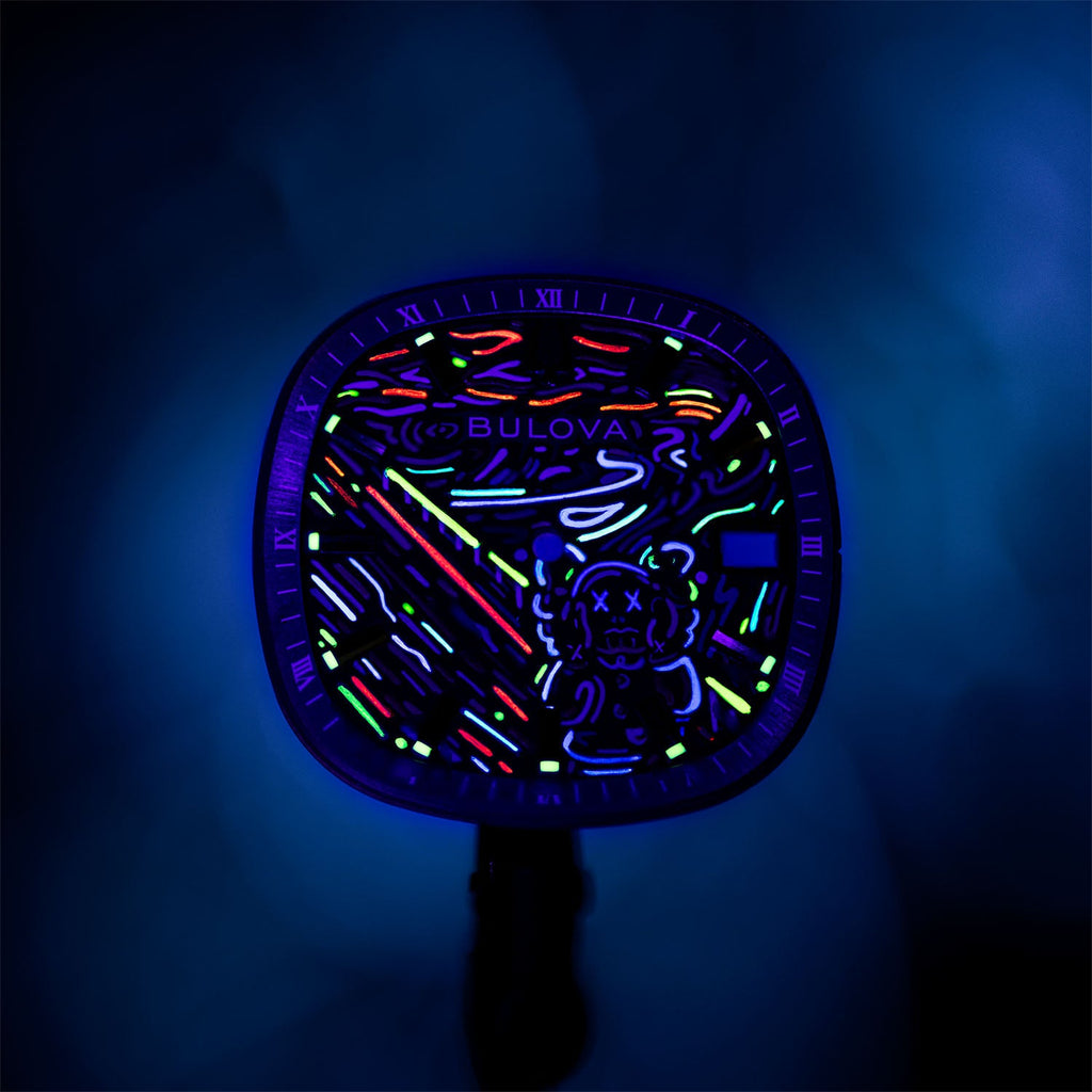 Bulova Super Seville Scream — The dial under UV light, its neon strokes glowing pink, green, cyan and violet around the figure's outline, customized limited edition by IFL Watches