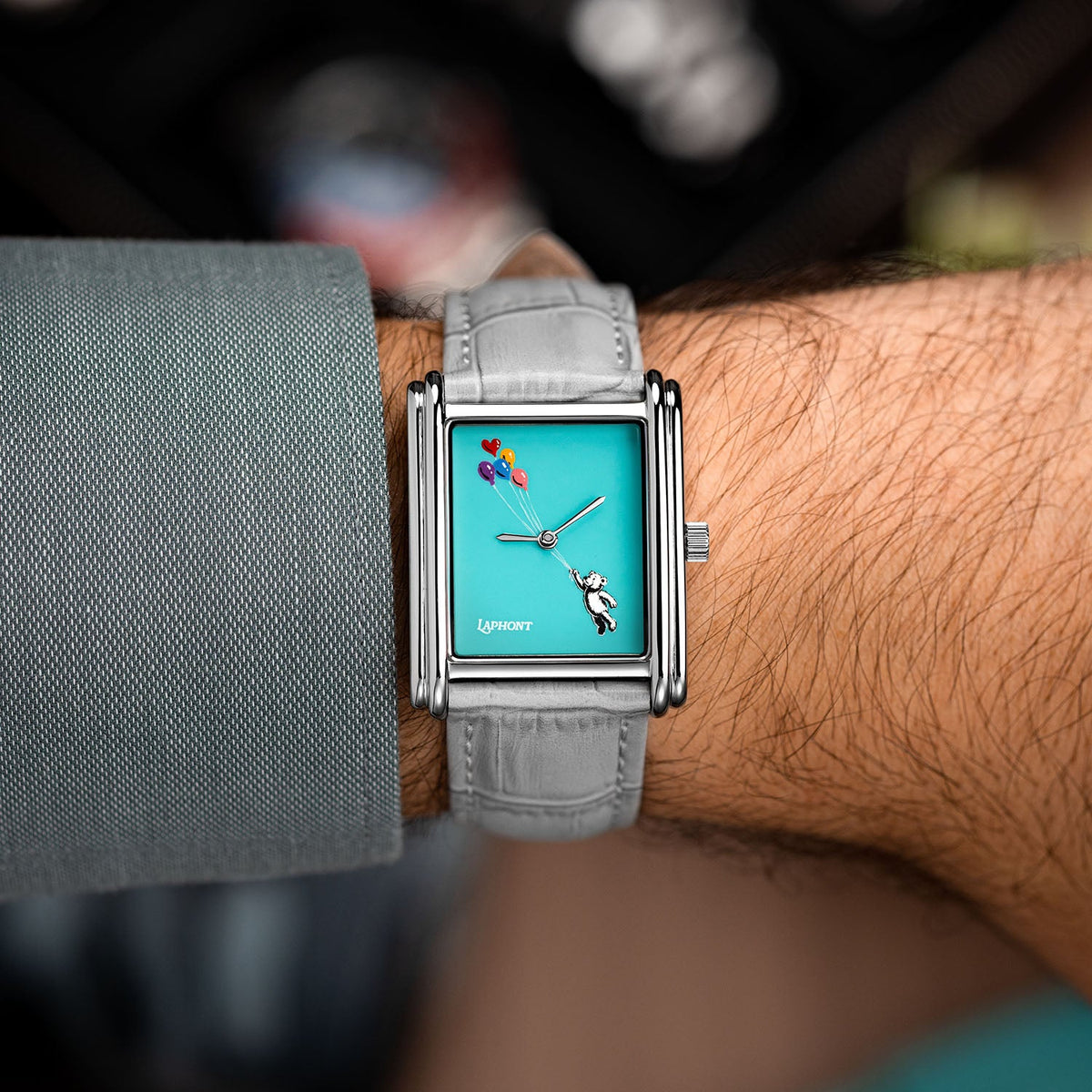 Laphont Bloc Cloudling — Seen from above on the wrist, the grey sleeve pushed back from the stepped steel case and the teddy bear rising on its balloons, a custom limited edition watch by IFL Watches