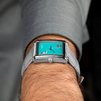 Laphont Bloc Cloudling — Side view on the wrist from the crown, the slim profile of the stepped steel case resting under a grey shirt cuff, a hand-painted limited edition watch by IFL Watches