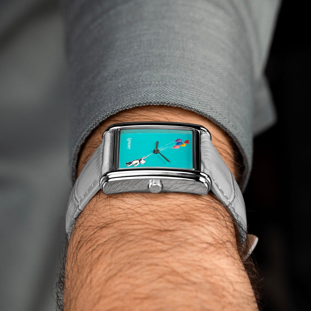 Laphont Bloc Cloudling — Side view on the wrist from the crown, the slim profile of the stepped steel case resting under a grey shirt cuff, a hand-painted limited edition watch by IFL Watches