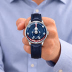 Mandetbrote Orbital Blue Kiss — Held in hand against a light blue shirt, showing the folding minute arm, available at IFL Watches.