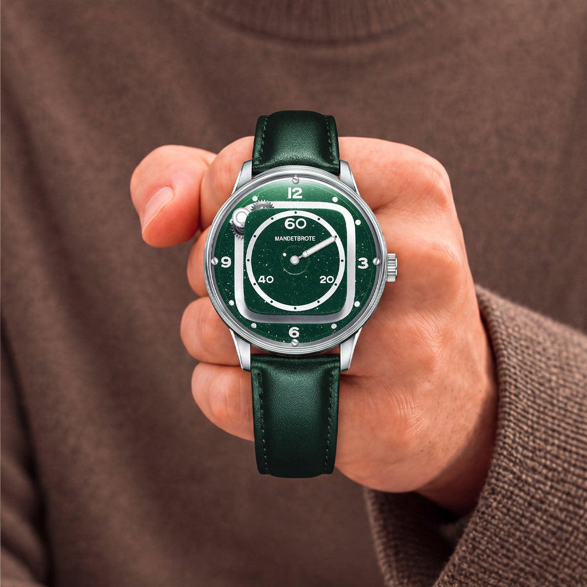 Mandetbrote Orbital II Green — Held in hand against a brown knit sweater, showing the star-flecked dial, available at IFL Watches.