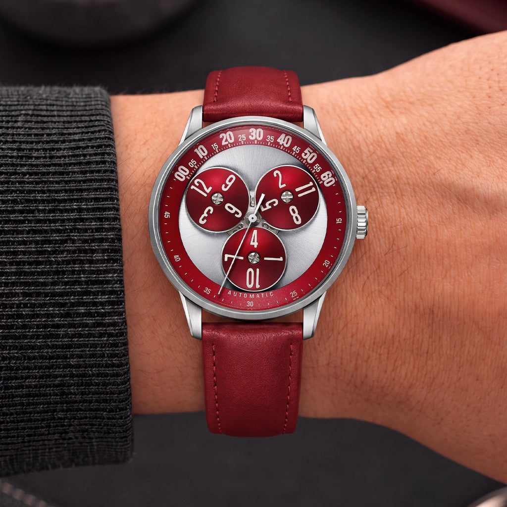 Mandetbrote Wandering Hour Burgundy — Worn on wrist with a charcoal sleeve, showing the wandering hour display, available at IFL Watches.