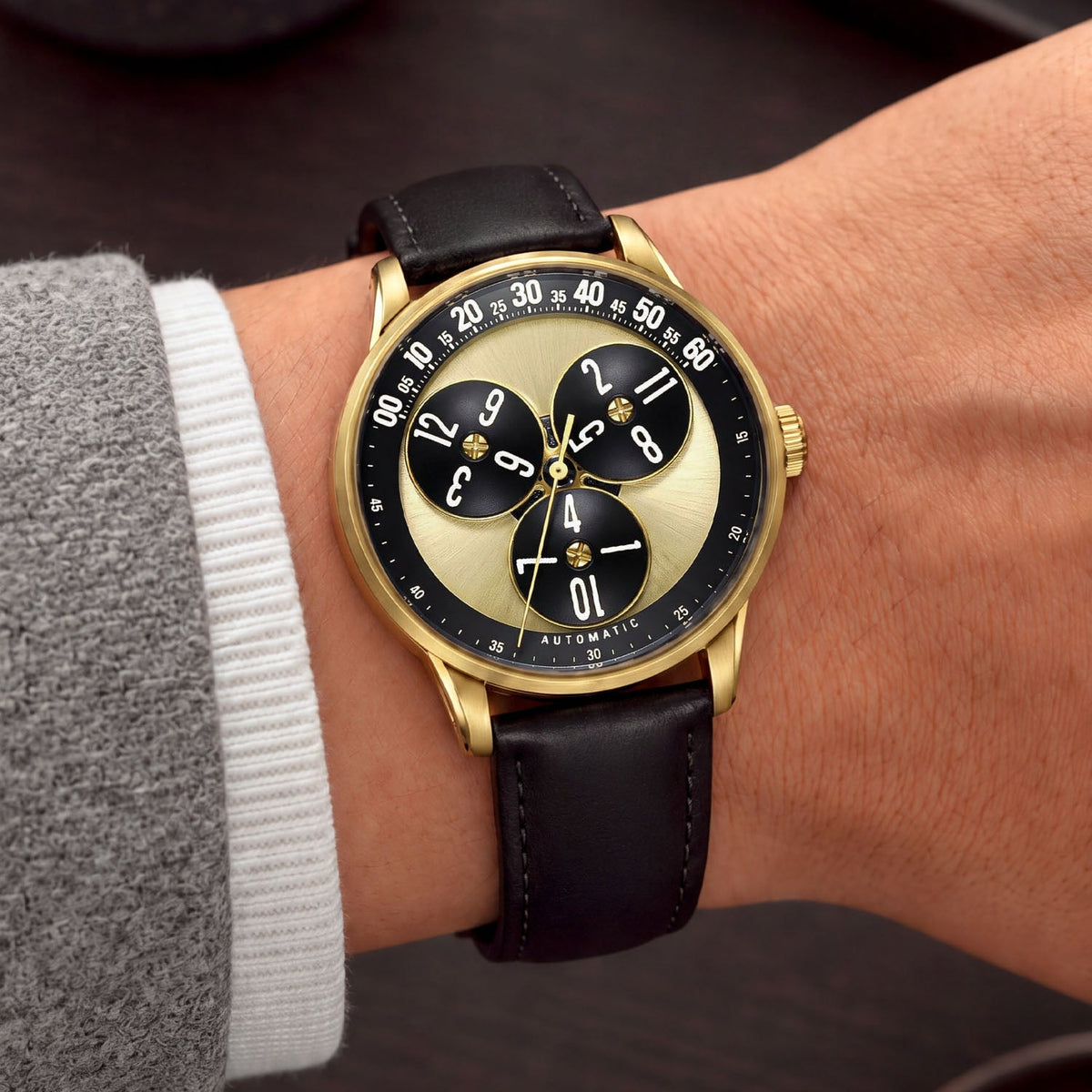 Mandetbrote Wandering Hour Gold — Worn on wrist at an angle, showing the minute arc and hour discs, available at IFL Watches.