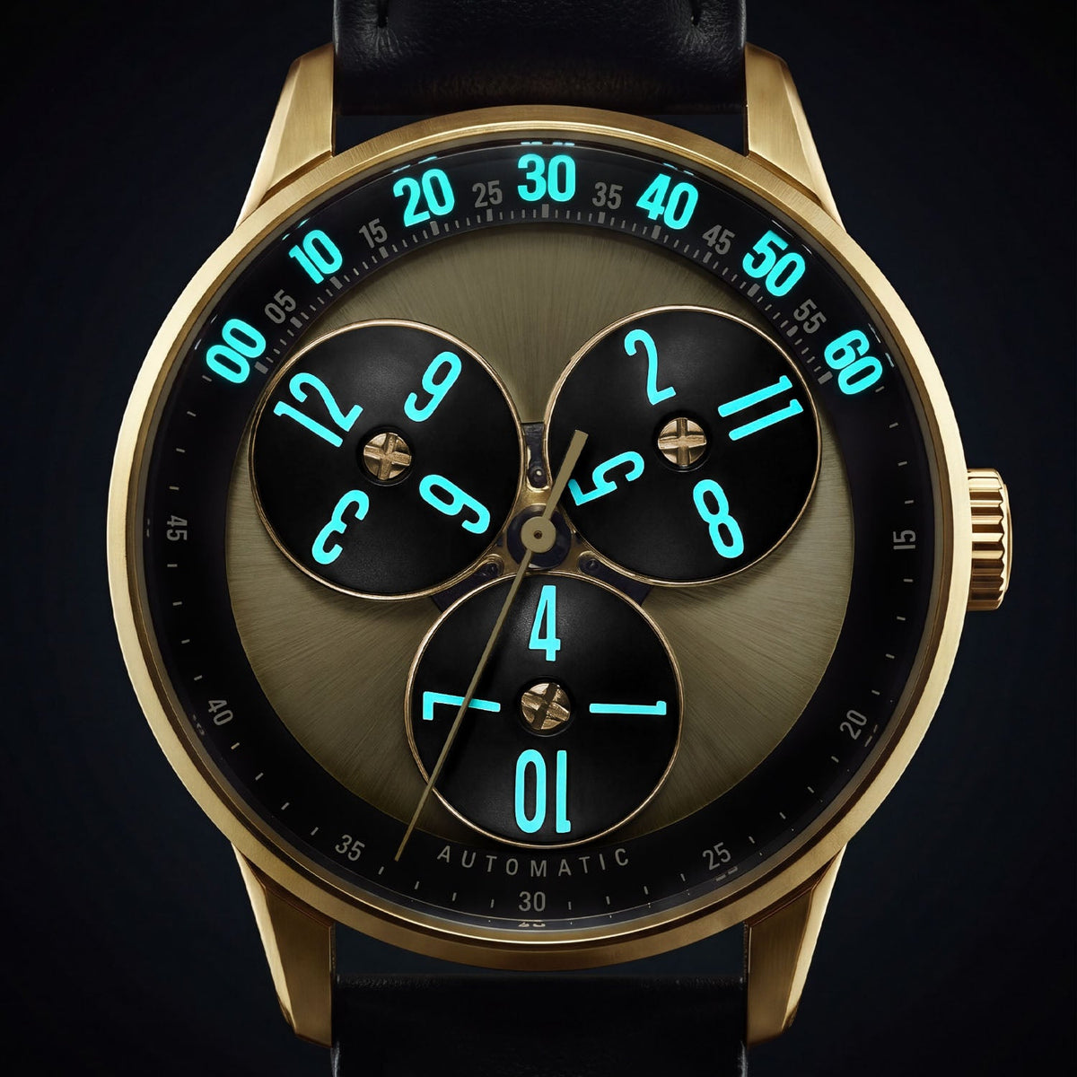 Mandetbrote Wandering Hour Gold — In the dark, with the hour numerals and minute track glowing, available at IFL Watches.