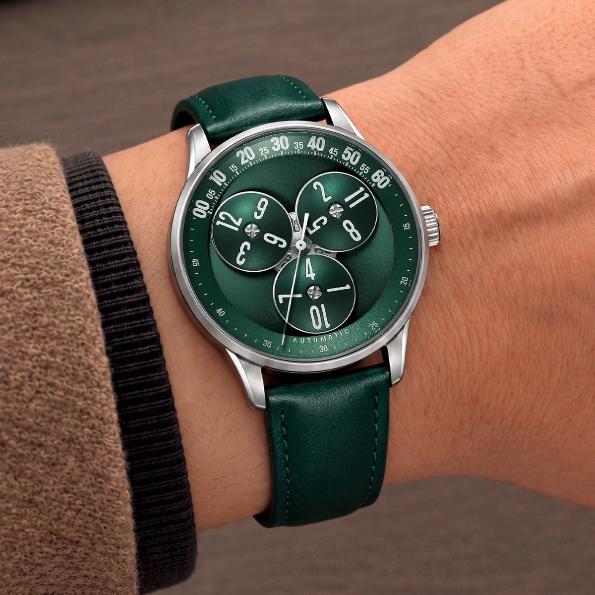 Mandetbrote Wandering Hour Green — Worn on wrist at an angle, showing the minute arc and hour discs, available at IFL Watches.