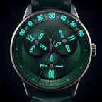 Mandetbrote Wandering Hour Green — In the dark, with the hour numerals and minute track glowing, available at IFL Watches.