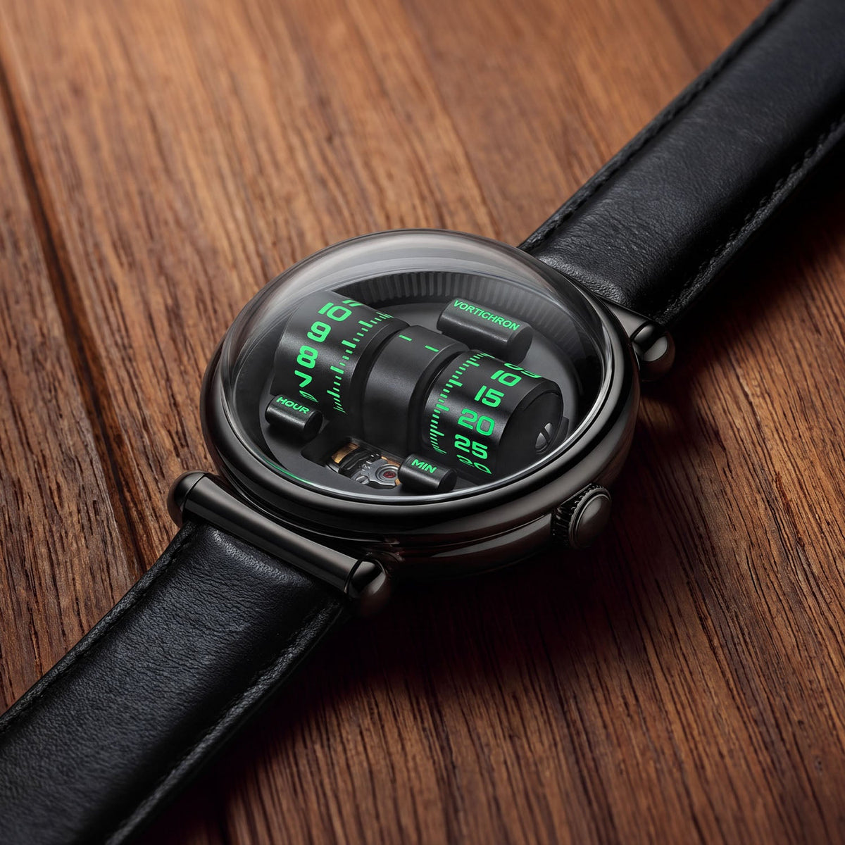 Vortichron Double Roller Midnight Black — Lying on wood, showing the green-lit rollers under the domed crystal, available at IFL Watches.