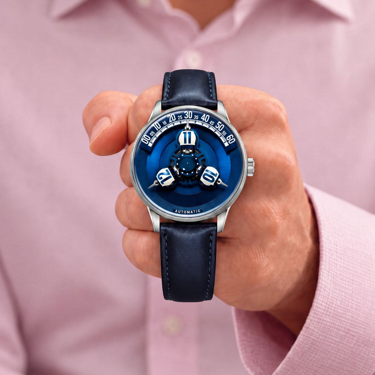 Vortichron Timeorb Blue — Held in hand against a pink shirt, showing the blue dial and white numbered spheres, available at IFL Watches.