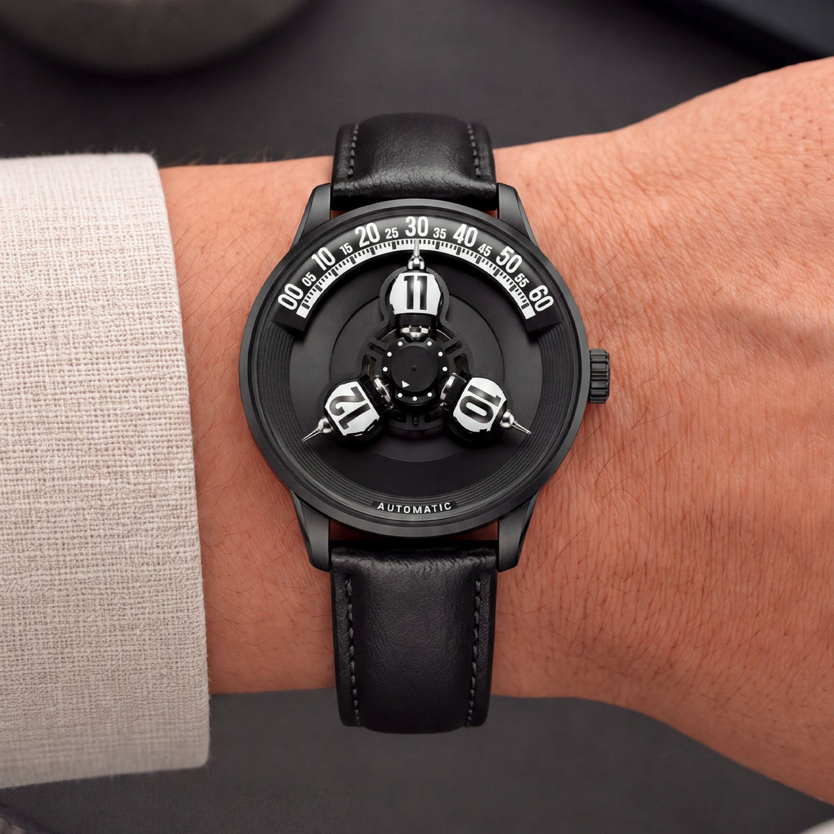 Vortichron Timeorb Midnight Black — Worn on wrist with a linen cuff, showing the hour spheres beneath the minute arc, available at IFL Watches.